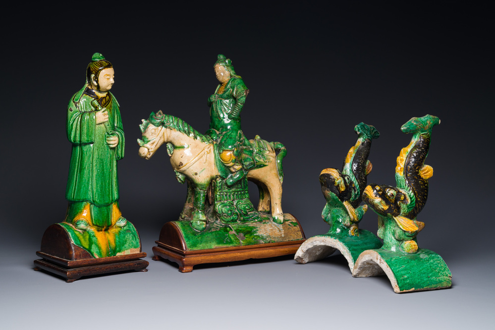 A pair of Chinese sancai-glazed roof tiles in the shape of fish, a warrior on horseback and a sage, Ming