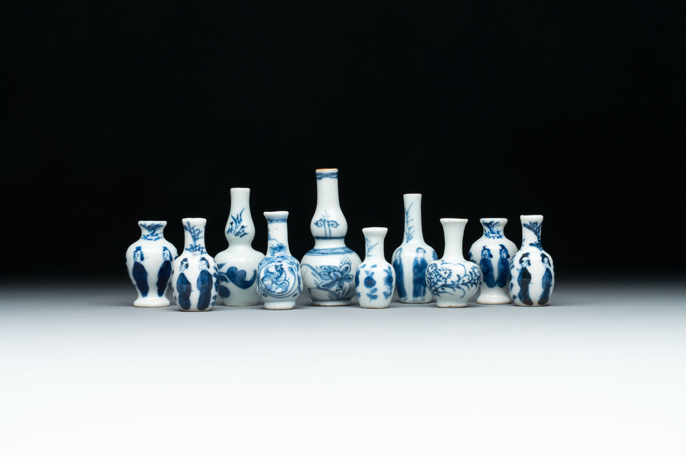 Ten Chinese blue and white miniature vases with figural and floral design, Kangxi