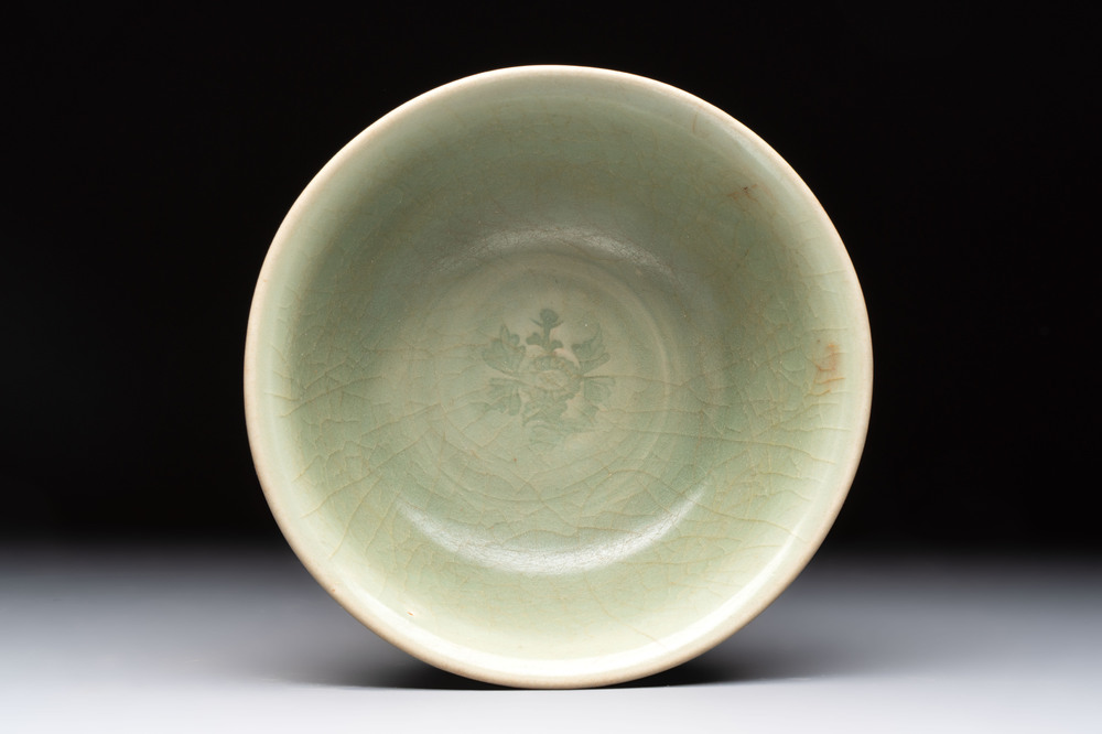 A Chinese Longquan celadon bowl with floral anhua design, Ming