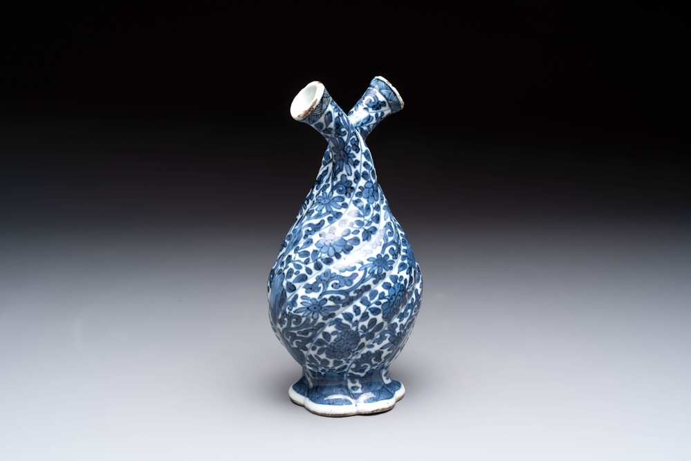 A Chinese blue and white double-spouted swirling-lobed cruet, Kangxi
