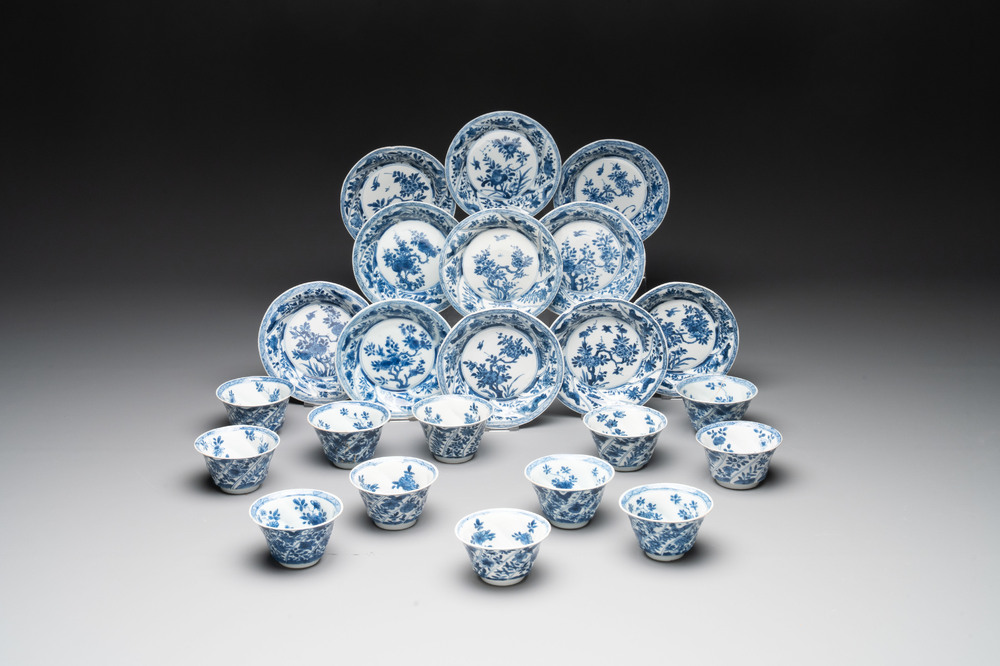 12 Chinese blue and white cups and 11 saucers with birds among flowering branches, Kangxi