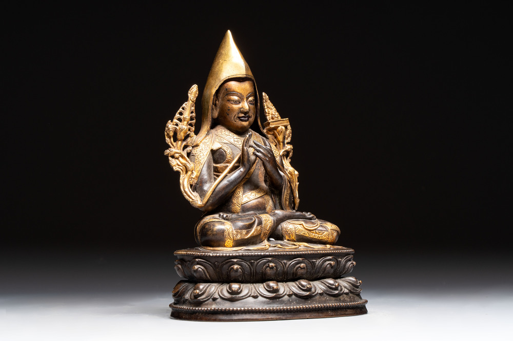A Tibetan parcel-gilt bronze sculpture of a lama, 20th C.