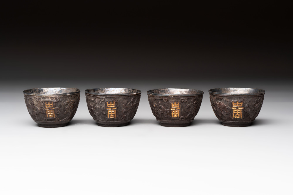 Four Chinese carved and silver-lined coconut cups, 19/20th C.