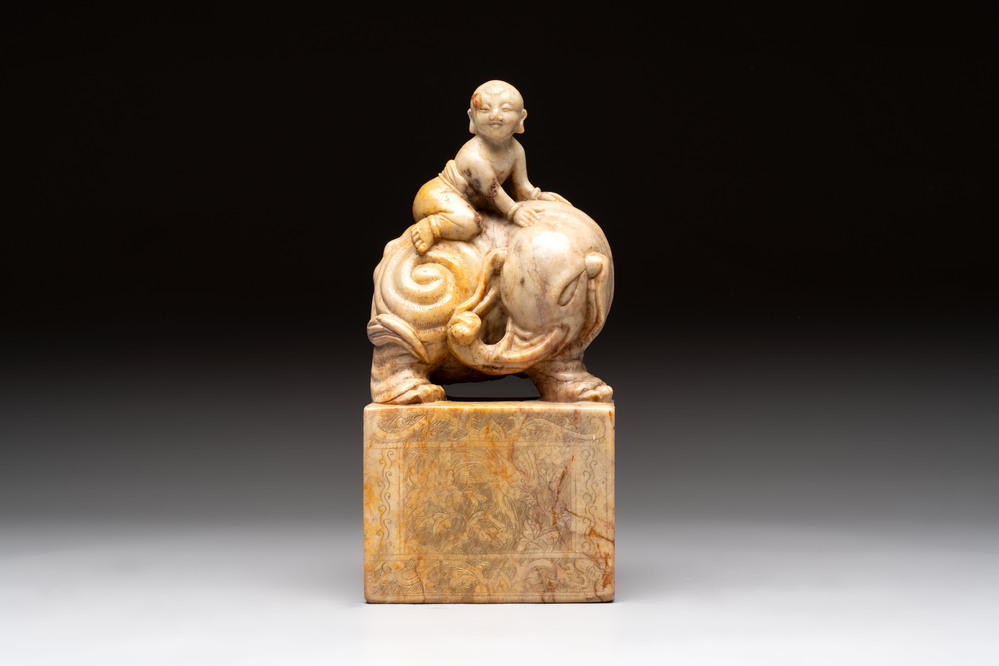 A Chinese soapstone carving of a boy riding an elephant, 20th C.