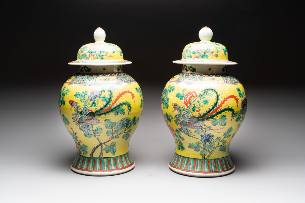 A pair of Chinese famille verte yellow-ground 'pheasants and peonies' vases and covers, 19th C.