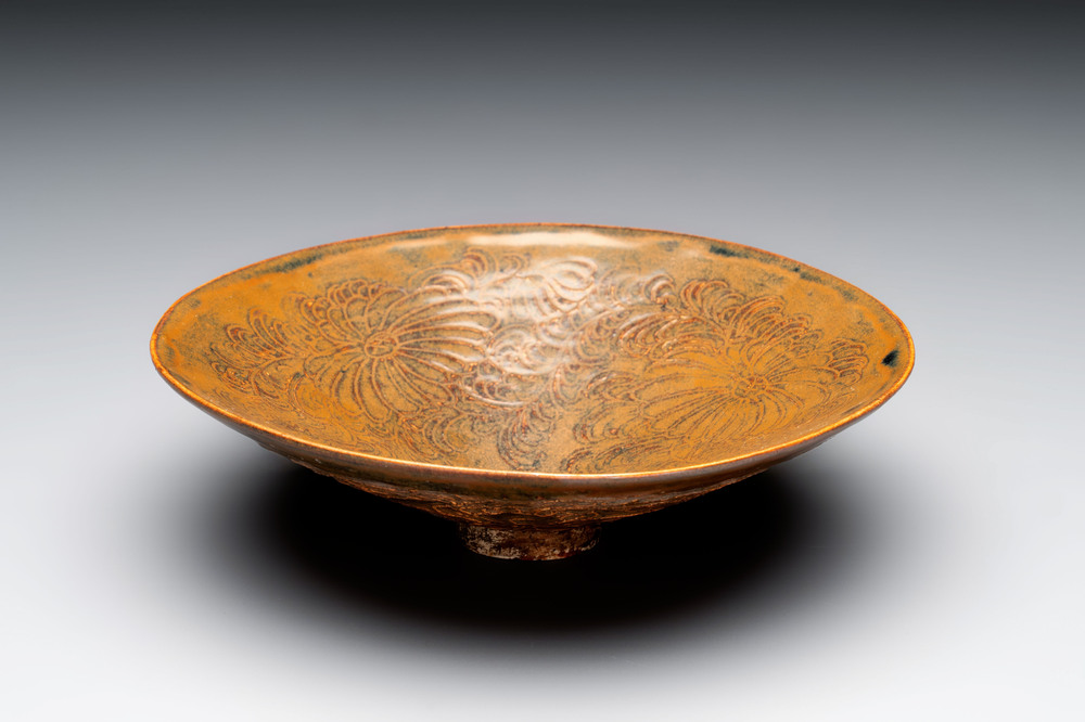 A Chinese Ding-type persimmon-glazed bowl with incised floral design, possibly Song