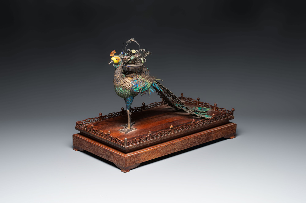A large Chinese precious stone-inset and enamelled gilt-silver filigree peacock and flower basket on a wooden stand, Republic