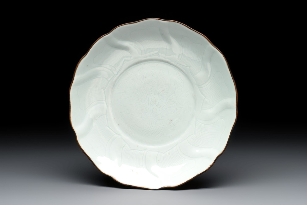 A Chinese moulded white-glazed plate with anhua floral design, Xuande mark, Ming