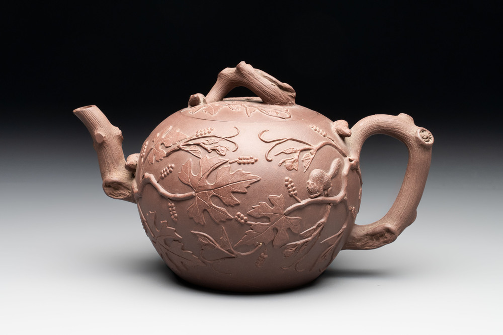 A Chinese Yixing stoneware 'squirrels among grape vines' teapot and cover, Kangxi