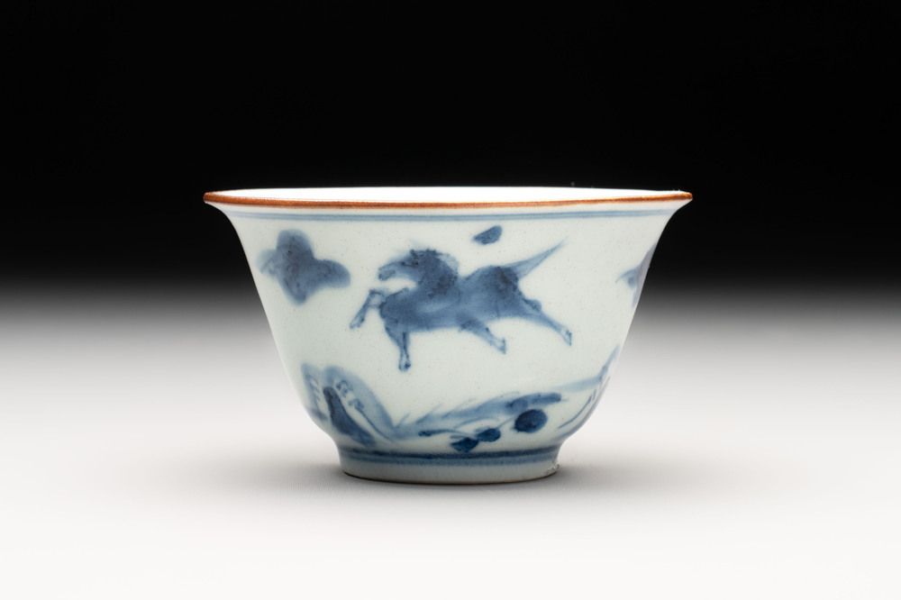 A Chinese blue and white 'flying horses' cup, Da Qing Bing Wu Nian Zhi 大清丙午年製 mark, dated 1666