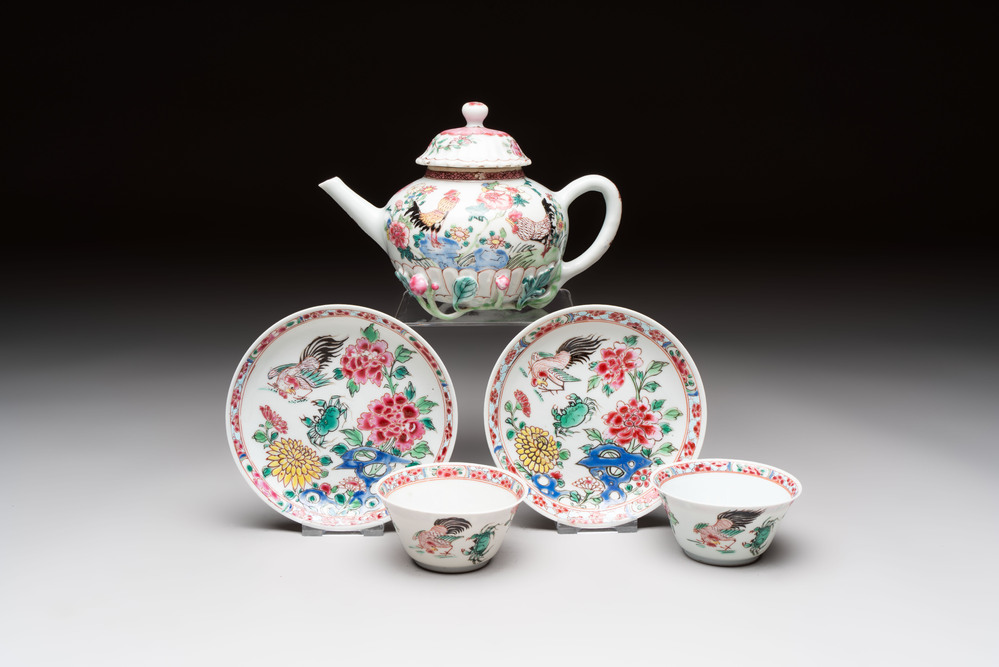 A Chinese famille rose 'roosters' covered teapot and two cups and saucers, Yongzheng