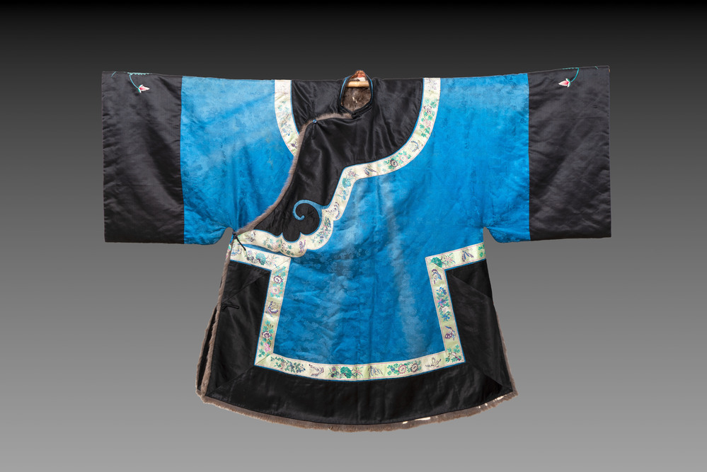 A rare Chinese blue-ground embroidered silk 'butterflies and flowers' robe, lined with fur, 19th C.