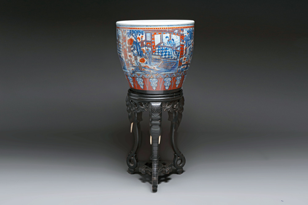 A large Chinese European-decorated blue and white fish bowl with narrative design, on a later wooden stand, Kangxi
