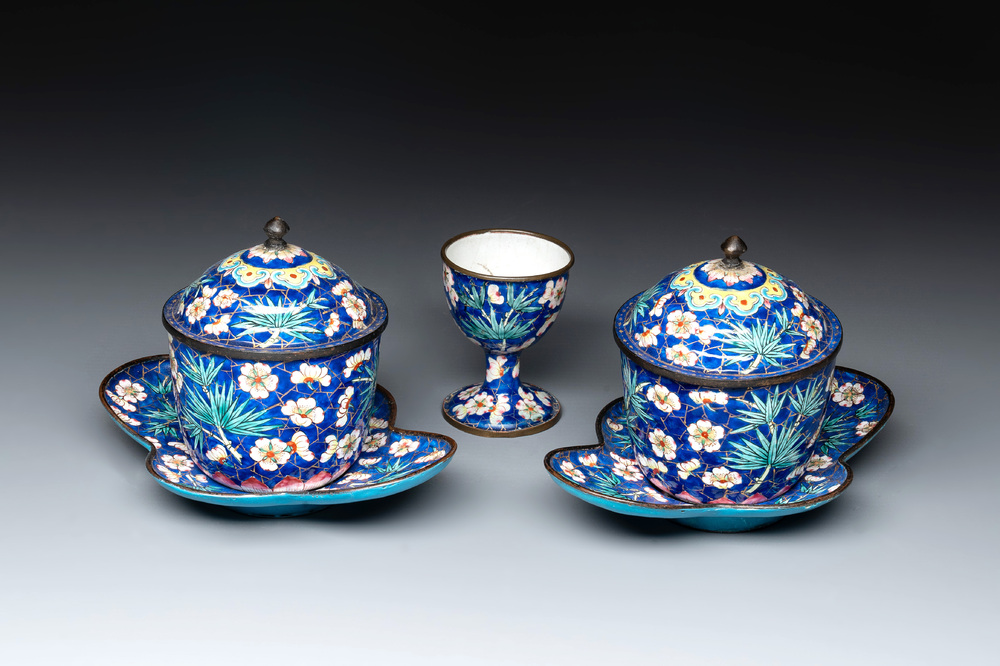 A pair of Chinese blue-ground Canton enamel covered bowls on stands and an egg cup, Qianlong/Jiaqing