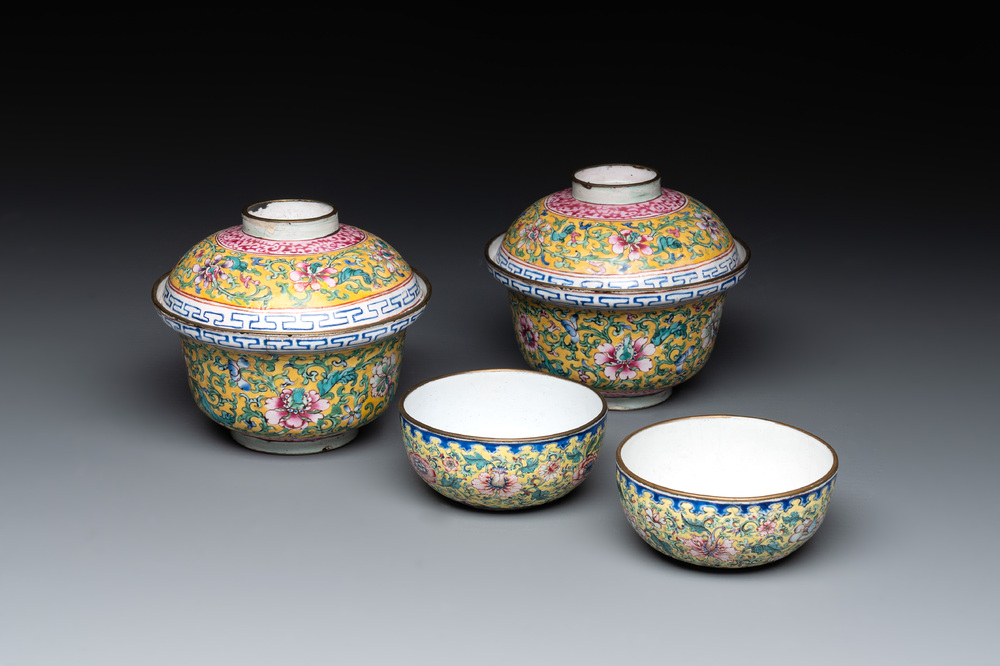 A pair of Chinese yellow-ground Canton enamel covered bowls and two cups, Yongzheng/Qianlong