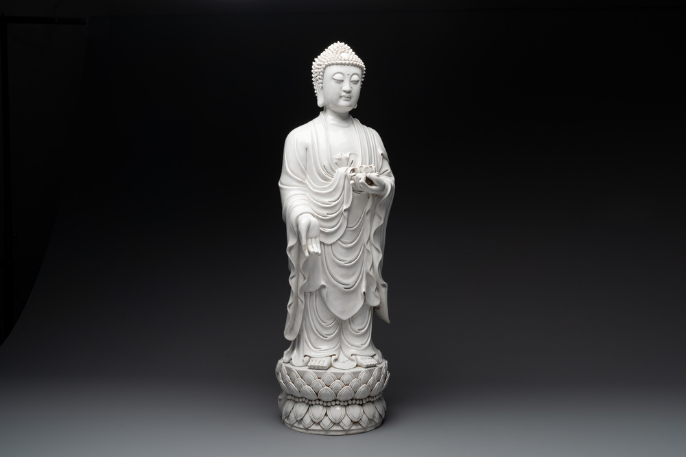 A large Chinese Dehua blanc de Chine figure of Buddha holding a lotus, He Chaozong 何朝宗 and Dehua 德化 mark, 20th C.