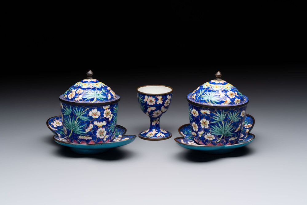 A pair of Chinese blue-ground Canton enamel covered bowls on stands and an egg cup, Qianlong/Jiaqing