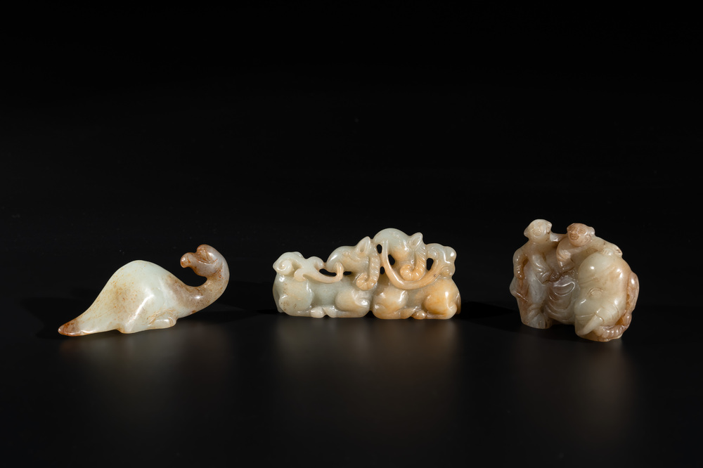 Three Chinese celadon and russet jade carvings of animals, 19th C.