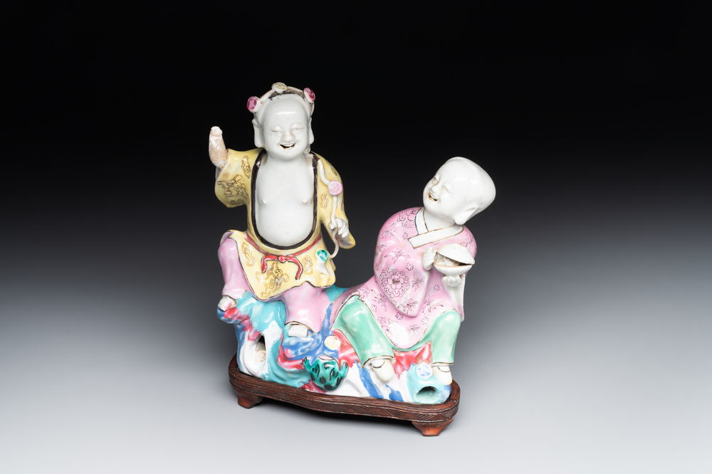 A Chinese famille rose 'Hehe Erxian' group on a wooden stand, Qianlong