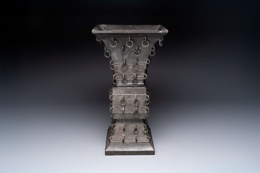 A large Chinese bronze quadrangular 'gu' vase with hanging rings, Ming
