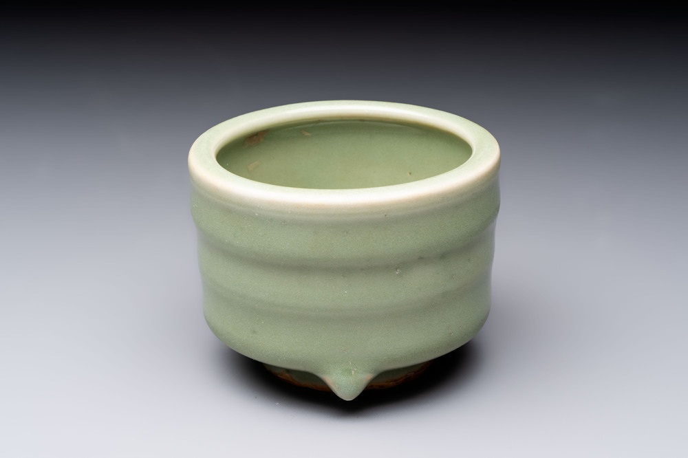 A small Chinese Longquan celadon cylindrical tripod censer, Ming