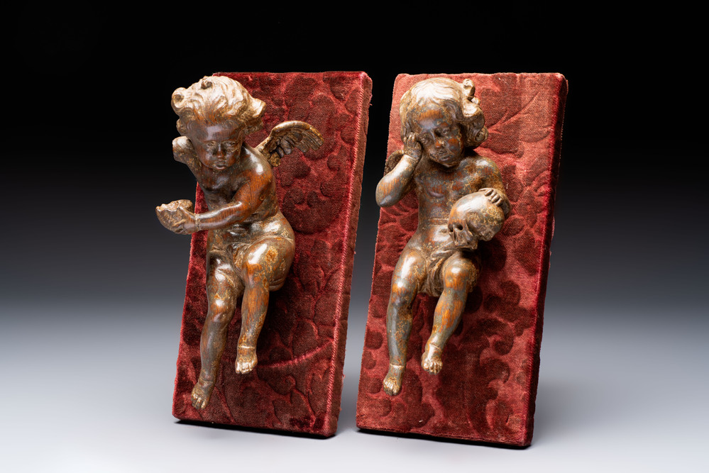 A pair of Flemish allegorical carved wood cherubs, 17th C.