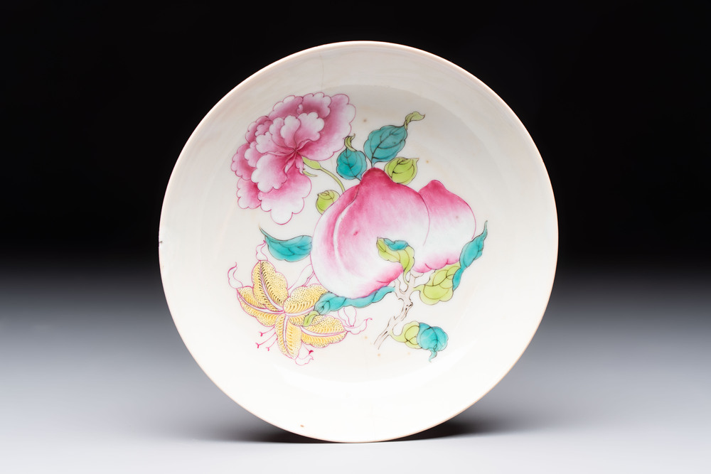 A Chinese famille rose ruby-back saucer dish with peaches and flowers, 18th C.