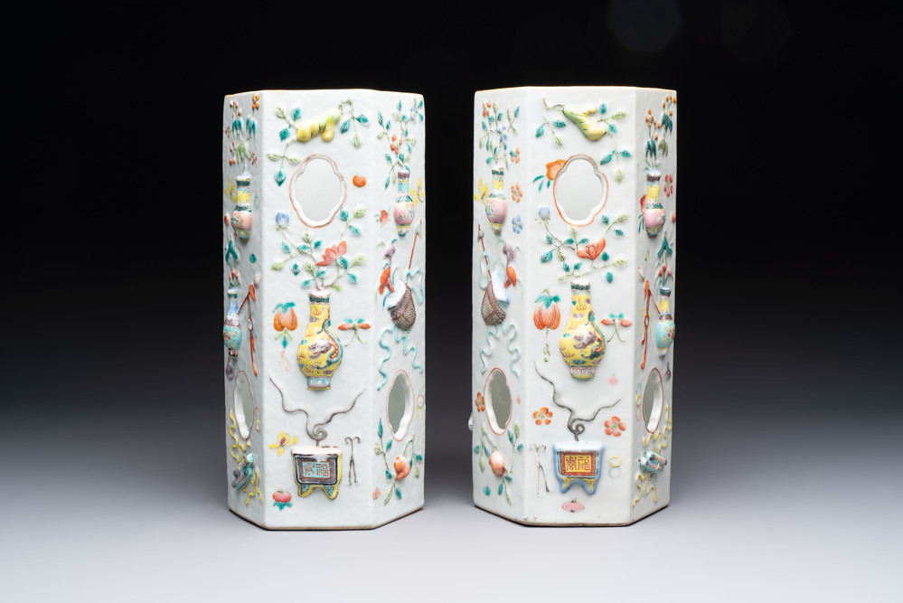 A pair of Chinese famille rose relief-moulded reticulated 'antiquities' hat stands, 19th C.