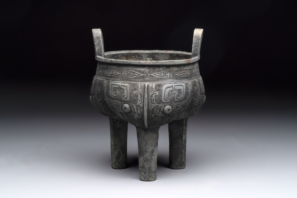 A Chinese archaic bronze tripod food vessel with 'taotie' design, 'ding 鼎', Western Zhou