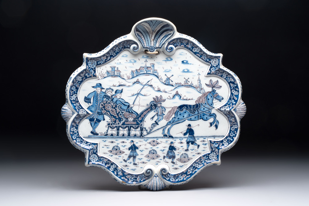 A blue, white and manganese Dutch Delft plaque with a winter scene, 18th C.