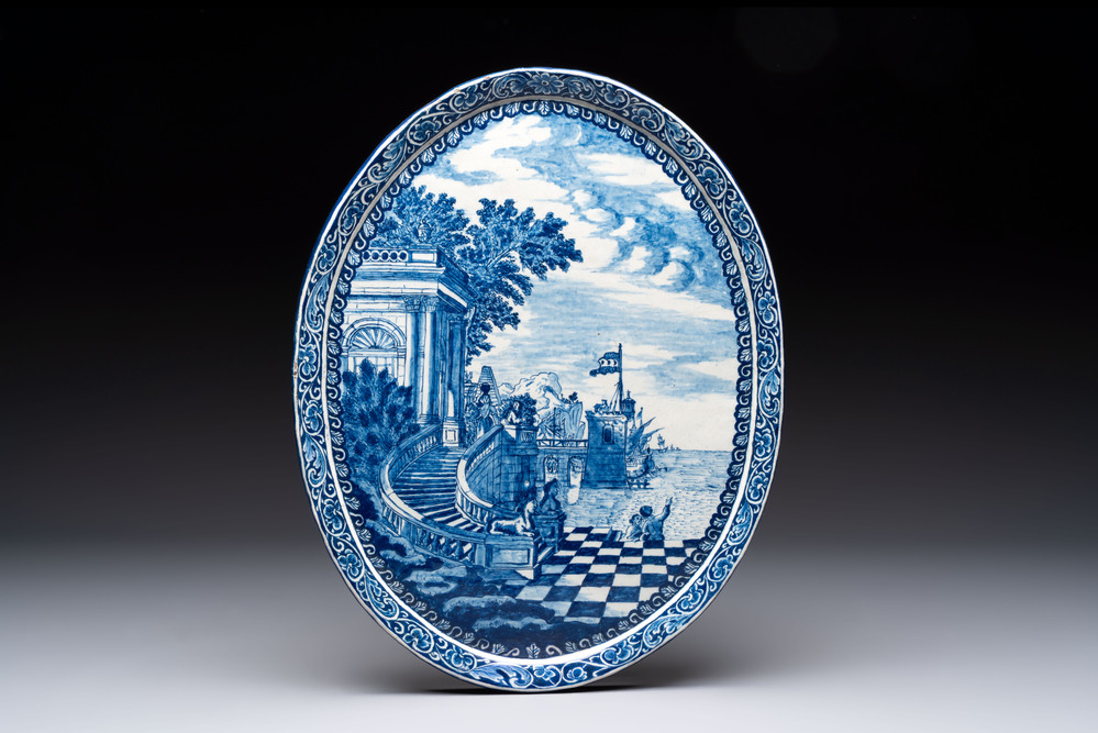 A blue and white Dutch Delft oval plaque with a Mediterranean seaport scene, after an engraving by Daniel Marot, 18th C.
