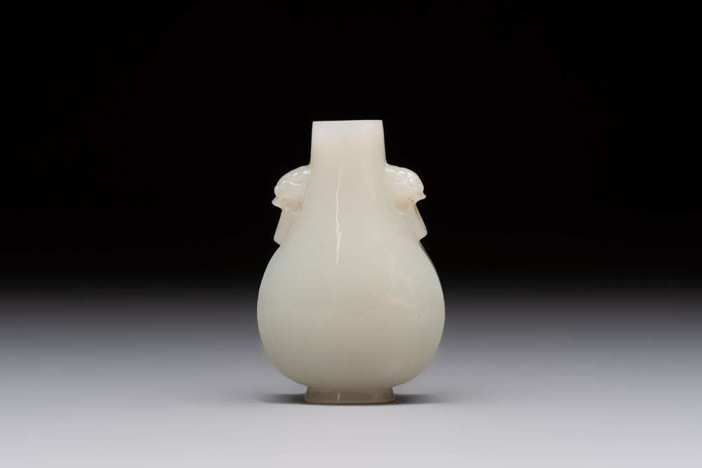 A Chinese white jade snuff bottle with lion-form handles, 19th C.