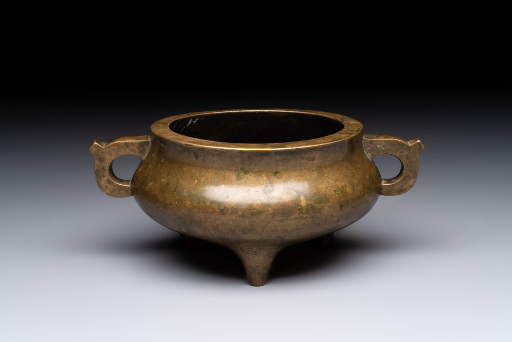 A Chinese bronze two-handled tripod censer, 19th C.
