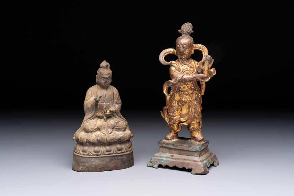 A Chinese bronze Taoist figure and a gilt-lacquered guardian, Ming