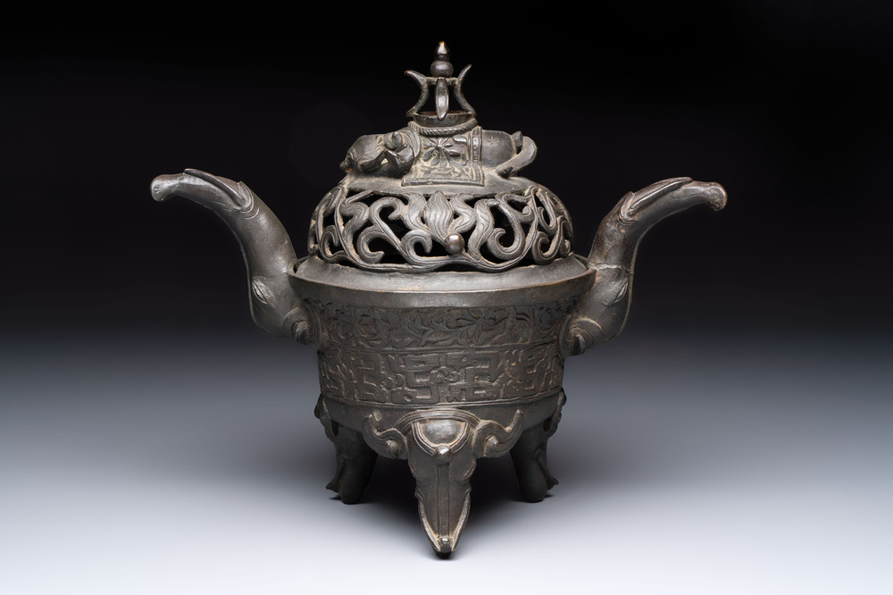 A Chinese bronze 'elephant' tripod censer and cover, Ming