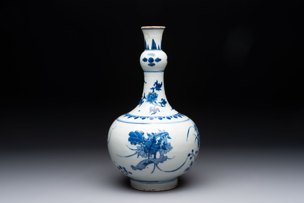 A Chinese blue and white bottle vase with floral design, Transitional period