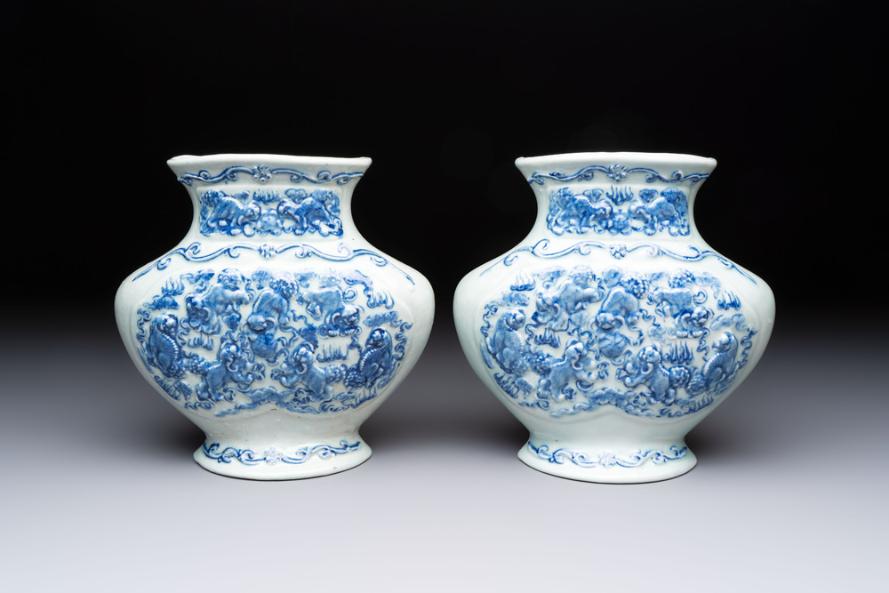 A pair of Chinese blue and white celadon-ground 'Buddhist lions' wall pocket vases, Yongzheng mark, 19/20th C.