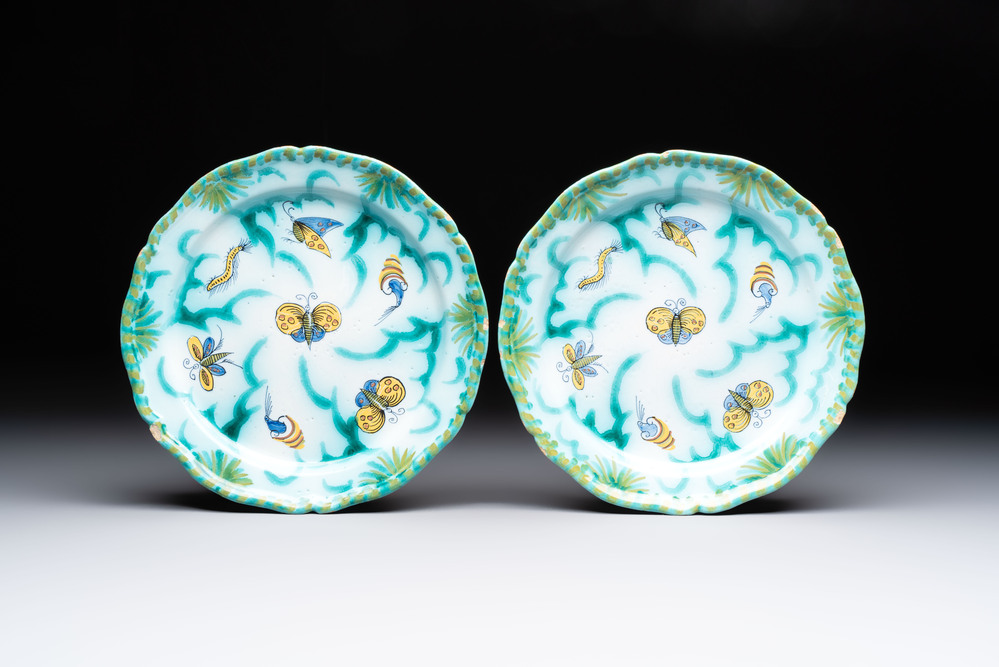 A pair of polychrome Brussels faience plates with butterflies and caterpillars, 18th C.