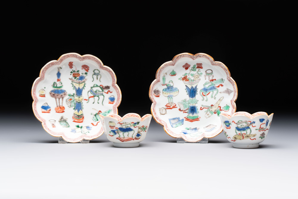 A pair of Chinese famille verte cups and saucers with antiquities, Kangxi