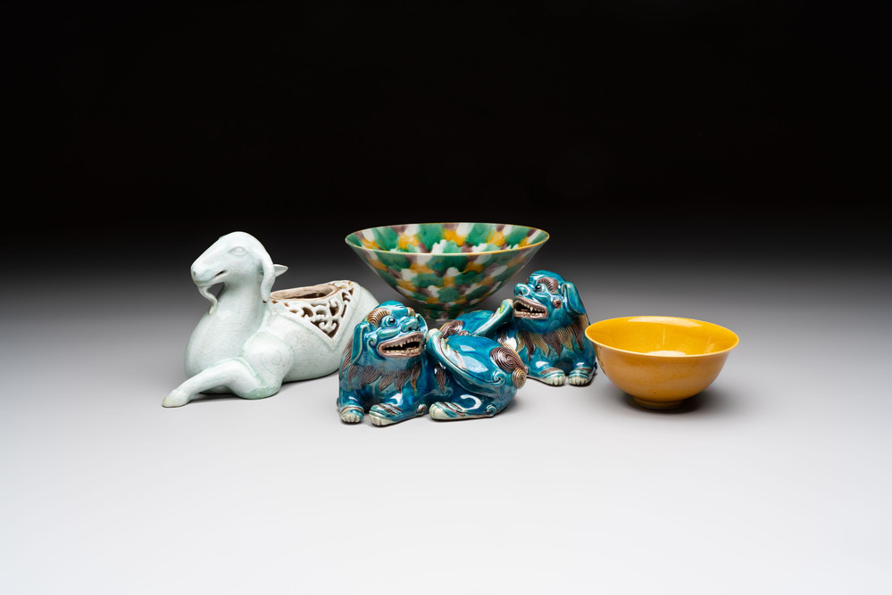 A pair of Chinese polychrome lions, a celadon-glazed goat, a yellow-glazed bowl and a sancai-glazed conical bowl, Chenghua mark, 19/20th C.