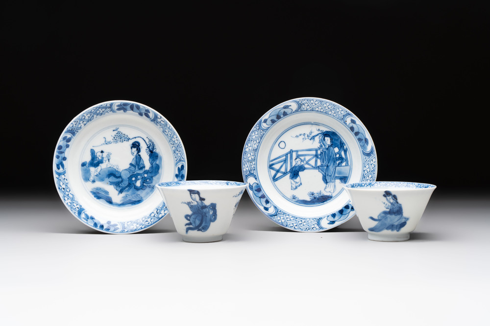 A pair of Chinese blue and white 'elegant beauty and boy' cups and saucers, Chenghua mark, Kangxi