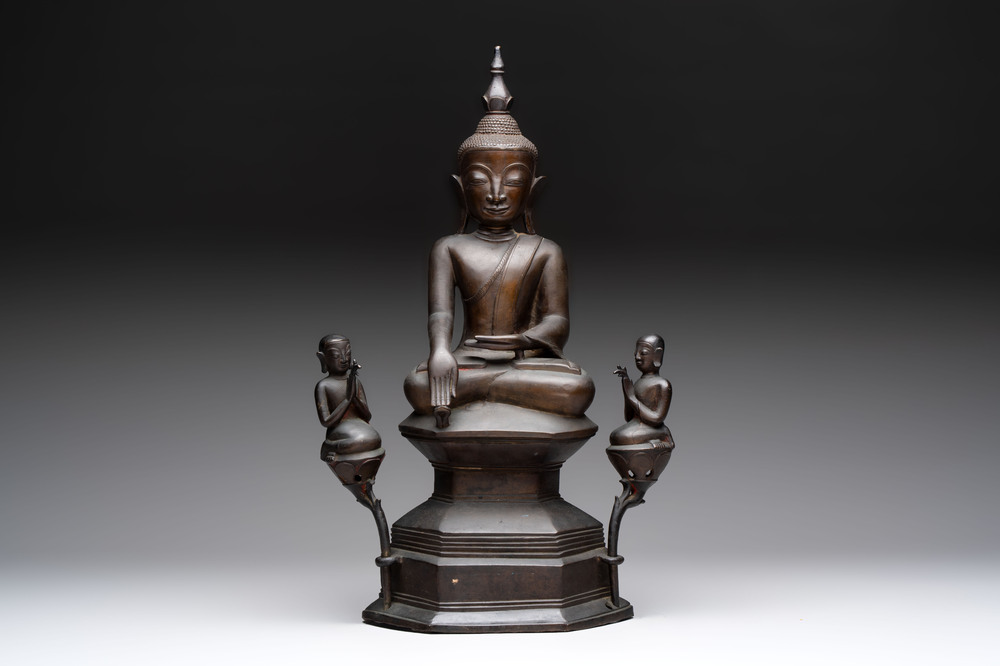 A large and fine Burmese bronze Buddha with two servants, 16/17th C.