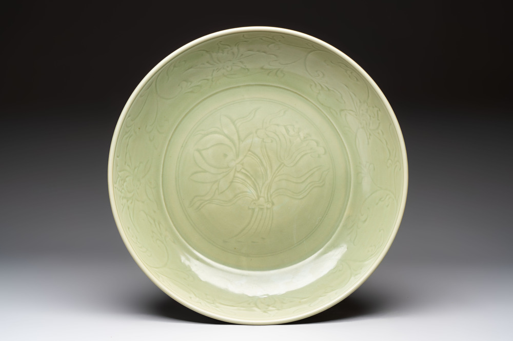 A rare and large Chinese Longquan celadon 'lotus bouquet' dish, Ming, early 15th C.