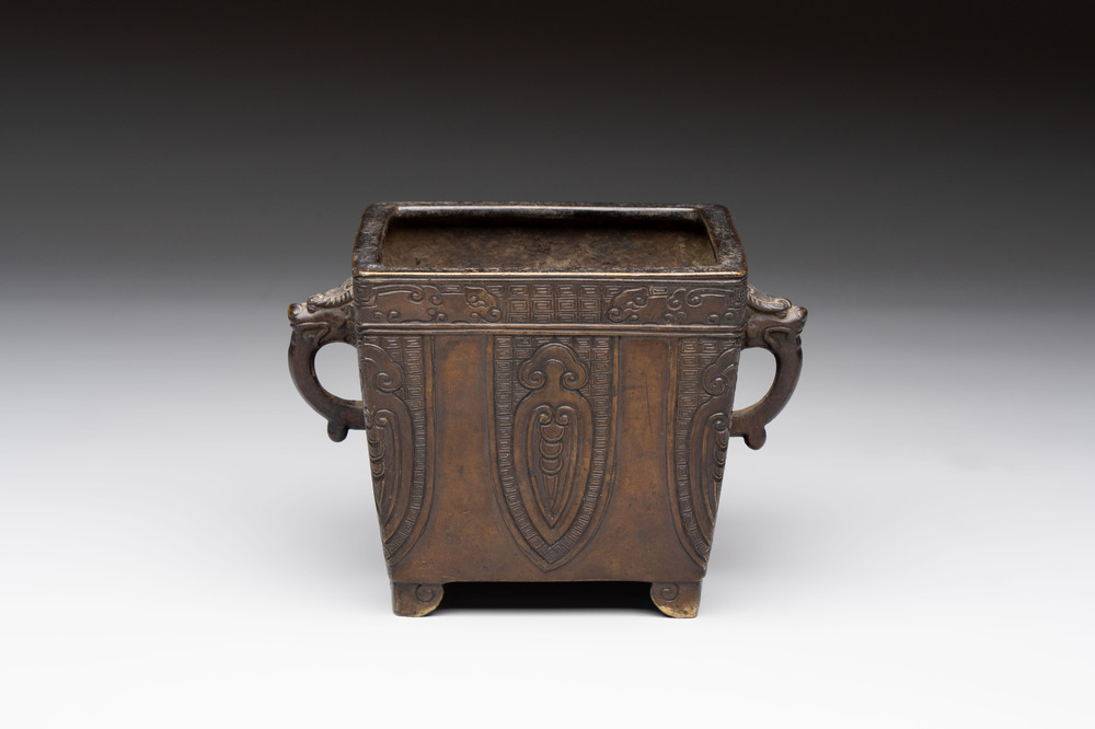 A Chinese archaistic bronze square censer with two handles, Xuande mark, Qing
