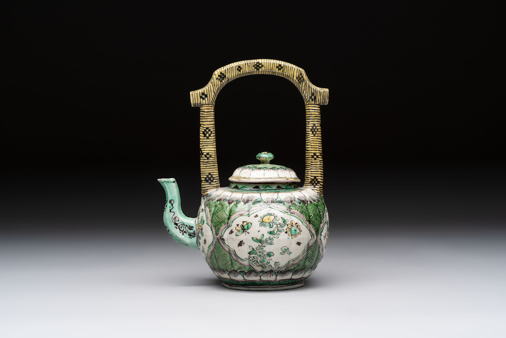 A Chinese verte biscuit teapot and cover with floral design, Kangxi
