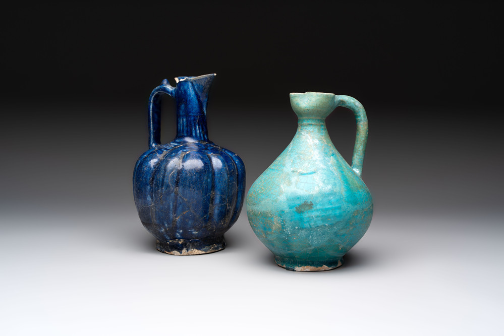 A Kashan turquoise-glazed ewer and a Nishapur blue-glazed ewer, Iran, 12th C.