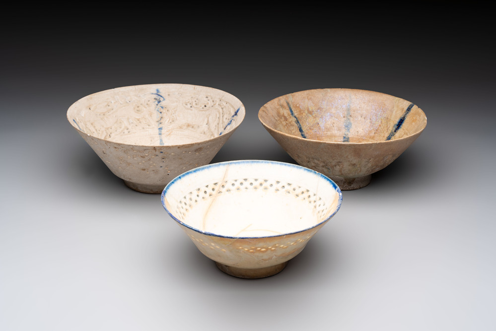 Three Kashan blue and white pierced pottery bowls, Iran, 12/13th C.