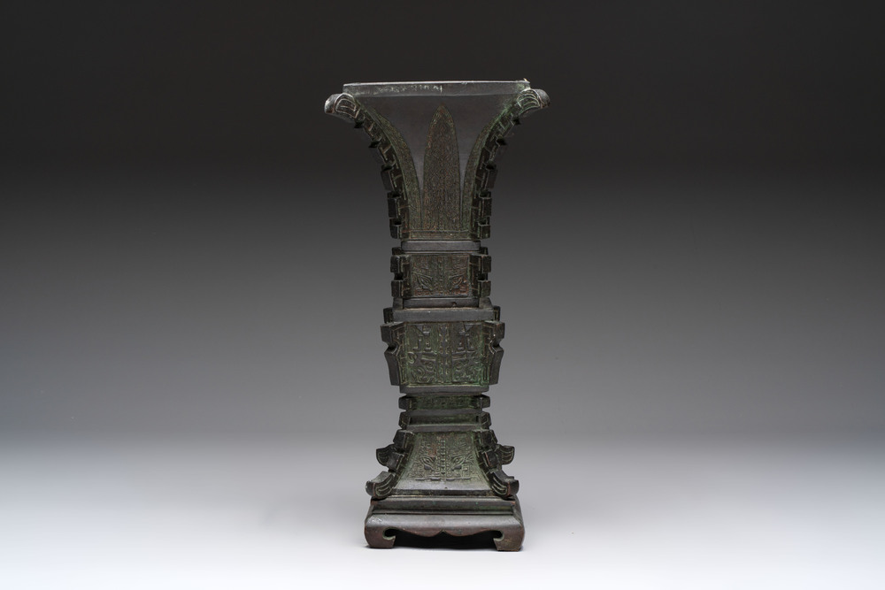 A Chinese archaistic bronze 'gu' vase and stand, Qing