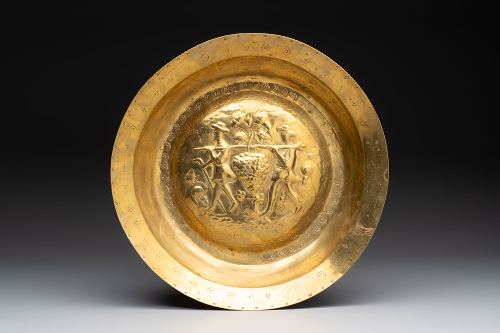 A German brass repouss&eacute; 'the Grapes of Canaan' dish, Nuremberg, 17th C.