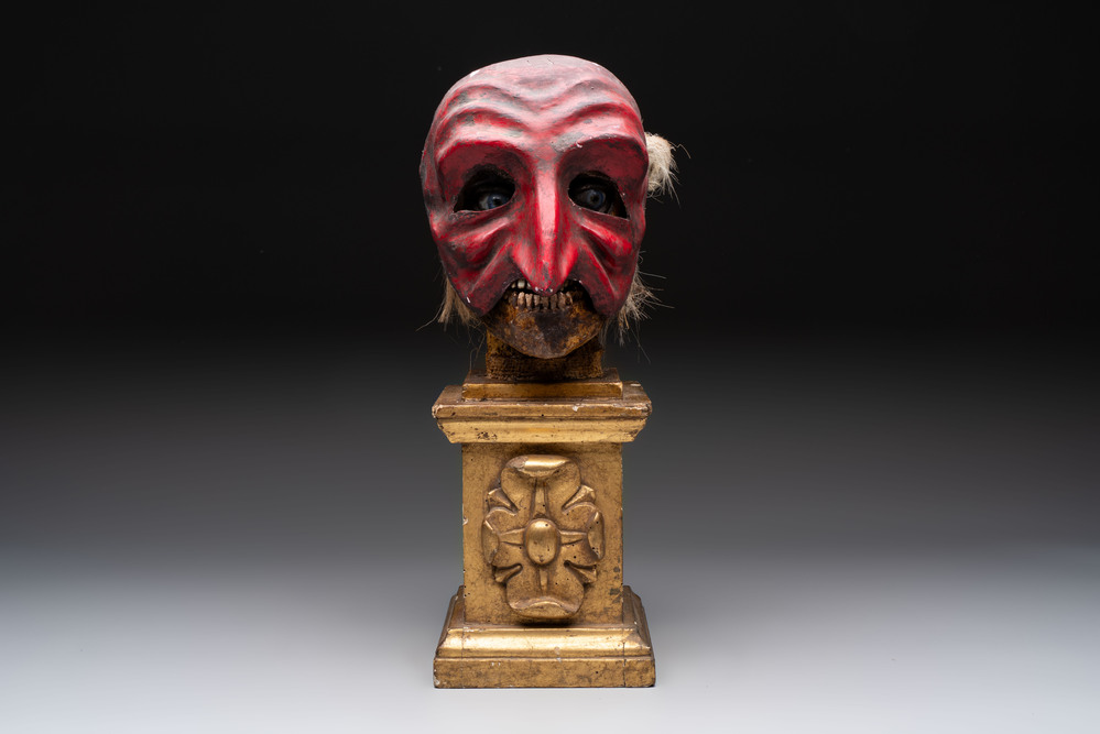 An Italian masked 'petrified' head on giltwood base, mixed media, 19/20th C.
